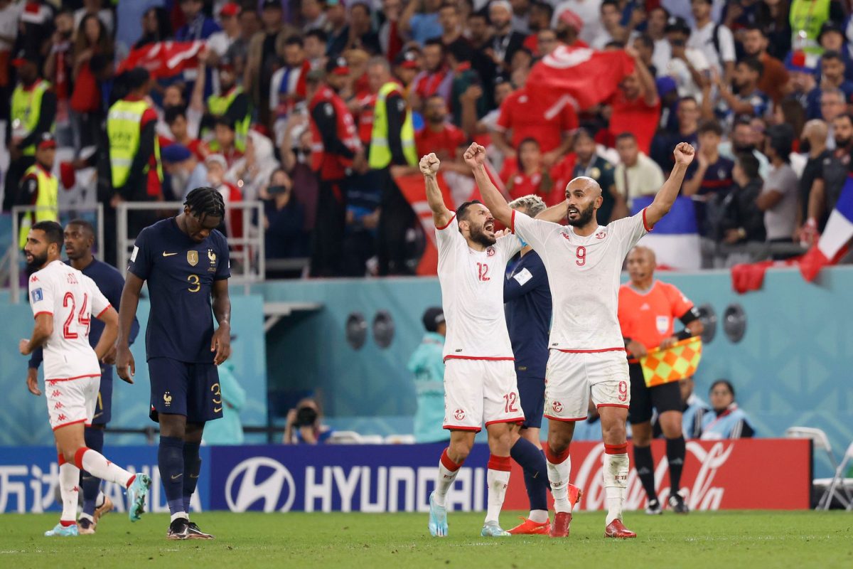 Tunisia defender Ali Maaloul (12) and forward Issam Jebali (9) celebrate after defeating France in a group stage match during the 2022 World Cup at Education City Stadium. Yukihito Taguchi-USA TODAY Sports