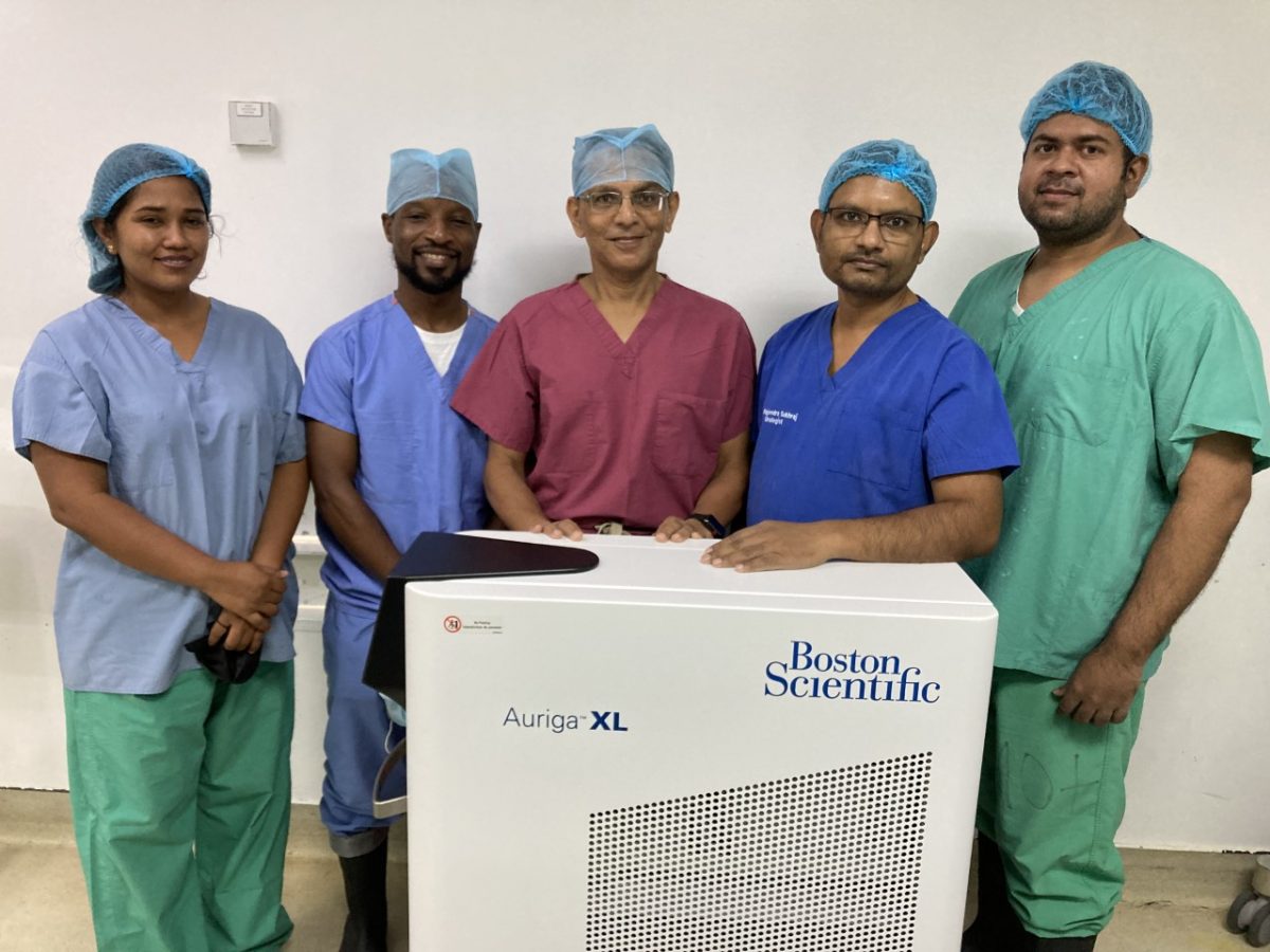 Urologists Dr Ravi Purohit (third from left) and Dr Rajendra Sukhraj (second from right) with the urology team and the machine. (GPHC photo)