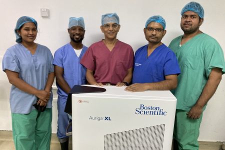 Urologists Dr Ravi Purohit (third from left) and Dr Rajendra Sukhraj (second from right) with the urology team and the machine. (GPHC photo)