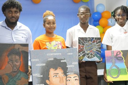 From left are Jamal Durant, Tia Adolphus, Jermain Garnett and Suriya Walcott with their paintings. (Massy Guyana photo)