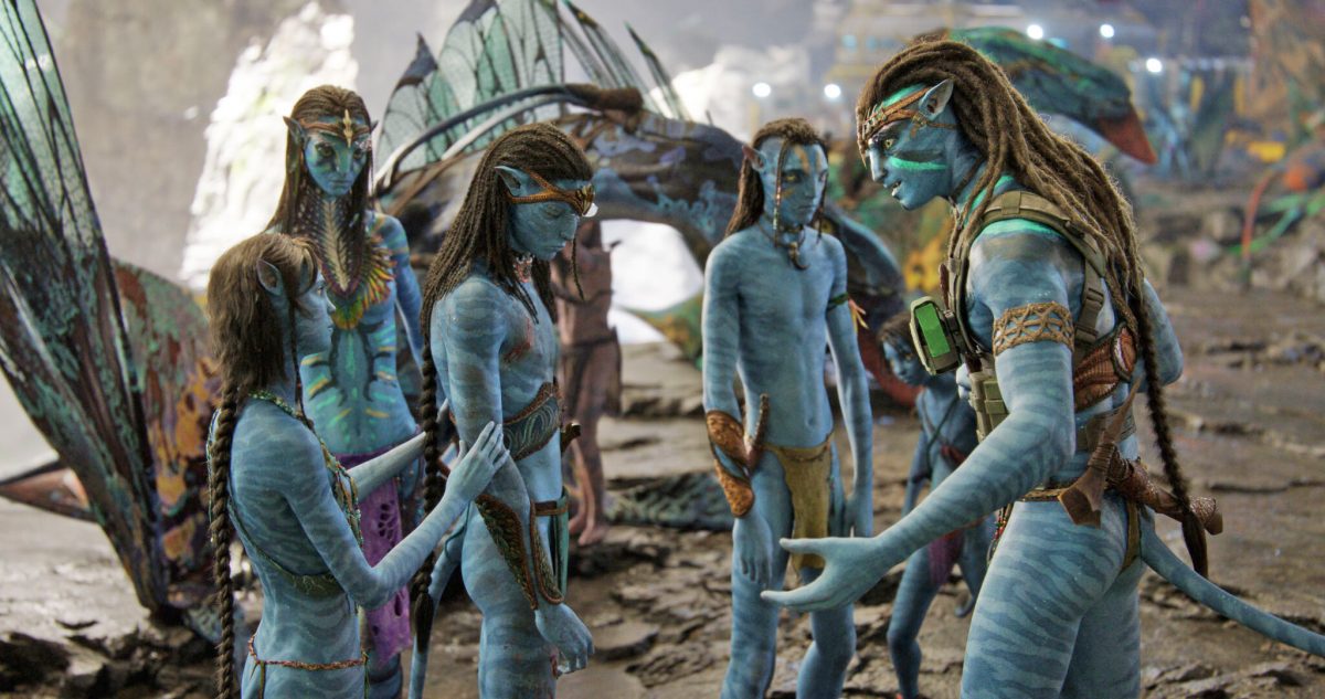 Some members of the Sully family in “Avatar: The Way of Water.” From left are Kira, played by Sigourney Weaver, Neytiri, played by Zoe Saldana, Neteyam, played by Jamie Flatters, Lo’ak, played by Britain Dalton, and Jake Sully, played by Sam Worthington. (Image via 20th Century Fox / Empire)