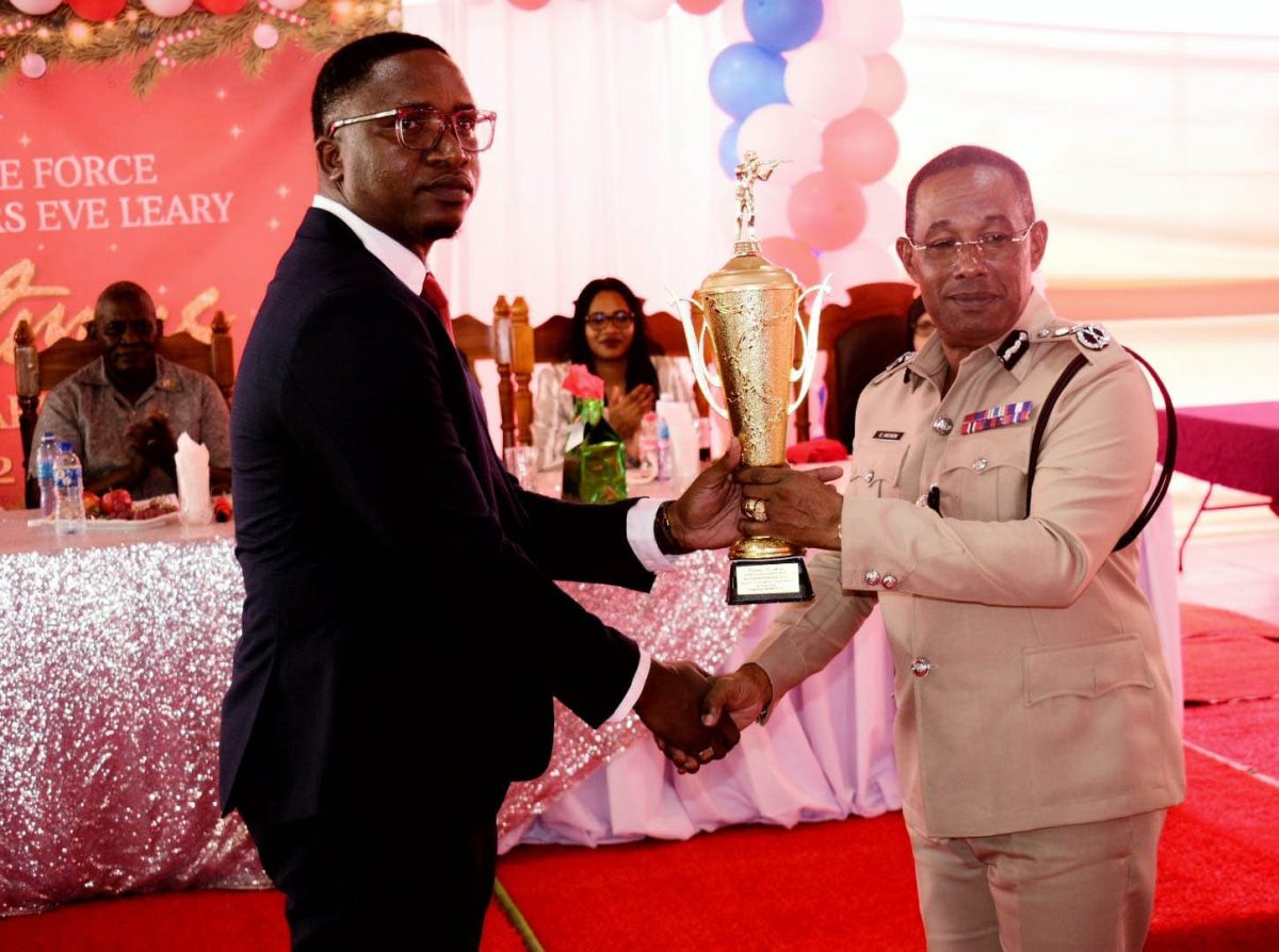 Sergeant Kester Cosbert (left) from Major Crimes Unit, who is the CID ‘Best Cop’ this year received a trophy from acting Commissioner of Police, Clifton Hicken. (Police photo)
