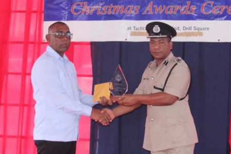 Superintendent Chabinauth Singh (left) received the overall Best Cop award from acting Deputy Commissioner, Administration, Calvin Brutus on Thursday at the Guyana Police Force’s annual Awards Ceremony (Guyana Police Force photo)