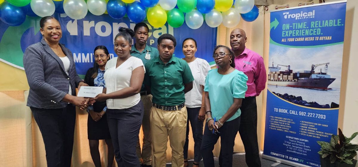 St. John’s College receives their gift vouchers from Tropical shipping’s Country Manager Glenis Hodge