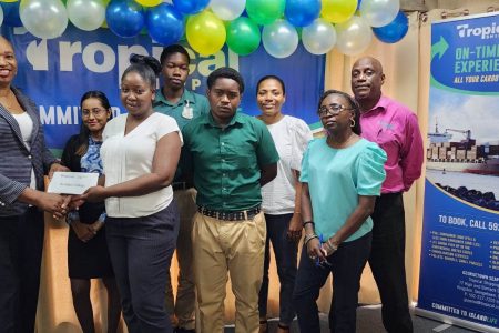 St. John’s College receives their gift vouchers from Tropical shipping’s Country Manager Glenis Hodge