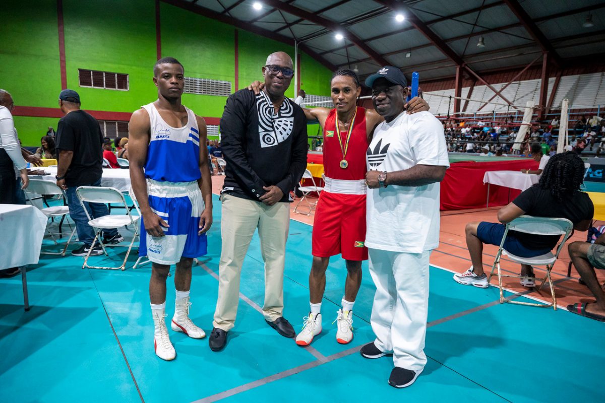 Guyana Boxing Association (GBA) President Steve Ninvalle (2nd from left), and Assistant Secretary/Treasurer Seon Bristol (right) posing alongside Featherweight champion Keevin Allicock (3rd from left) and divisional runner-up Samuel Greene of Suriname following the end of their bout