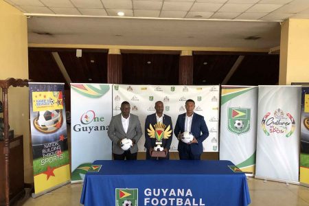 GFF President Wayne Forde (centre) displaying the championship trophy for the
One Guyana President Cup in the presence of Kashif and Shanghai Co-Director
Kashif Muhammad (right) and GFF Technical Director Bryan Joseph
