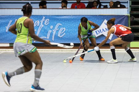 Woodpecker Hikers striker Clayza Bobb (centre) being challenged by Old Fort defender Tekeisha Deleon