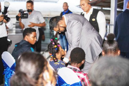 President Irfaan Ali engaging a youth at the launching of the Study Hub in Tiger Bay (DPI photo)
