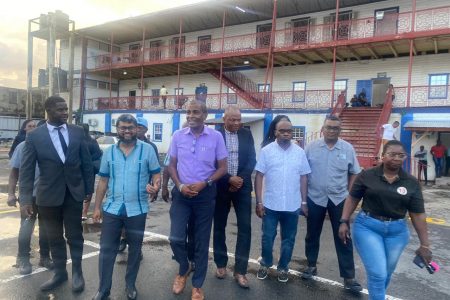 City Mayor, Ubraj Narine (second from left) and Opposition Member of Parliament, Sherod Duncan (third from right) after they were placed on $100,000 bail each. (PNCR photo)