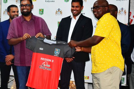 President Ali receiving the Region Three jersey from team manager Adrian Giddings
at the official launch of the One Guyana President Cup Championship phase