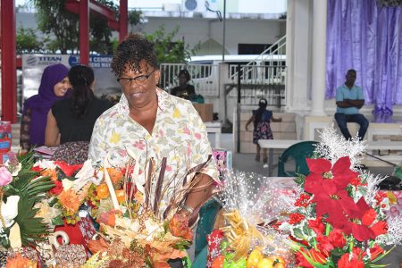 Patricia Sears and some of her floral arrangements