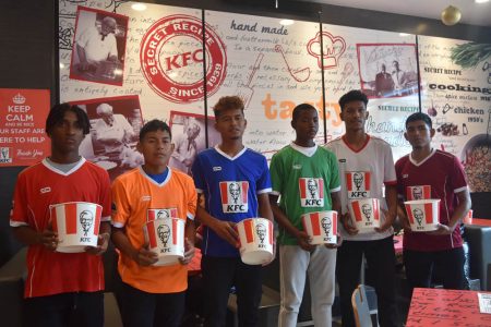 Calm before the storm! The competing teams in the KFC Goodwill Schools Football Series displaying their respective uniforms. From left are St. Benedict College of Trinidad and Tobago, Christianburg/Wismar, Annai Secondary, Golden Grove, SVB Academy of Suriname, and DC Caesar Fox [formerly Waramadong]. 