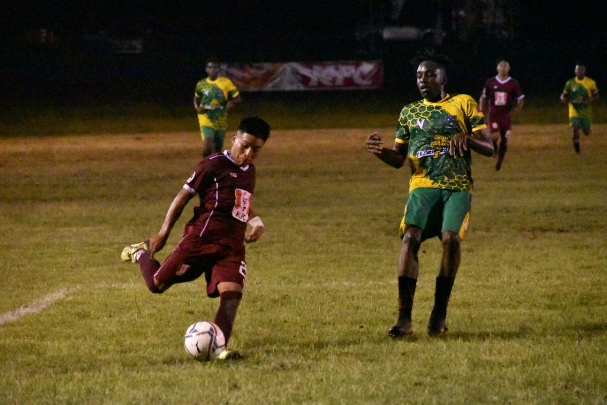 A scene from the DC Caesar Fox (red) and St. Benedict clash in the KFC Goodwill Schools Football Series at the Ministry of Education ground, Carifesta Avenue