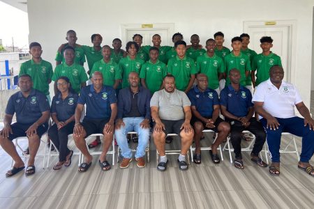Tournament coordinator Troy Mendonca (sitting 4th from right) and GFF President Wayne Forde (5th from right) posing with members of the SVB Academy of Suriname at the National Training Centre