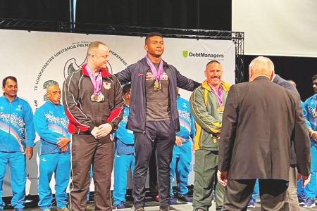 Carlos Petterson-Grifith (centre) on the podium following his heroics at the ongoing Commonwealth Powerlifting Championships in Auckland, New Zealand. 