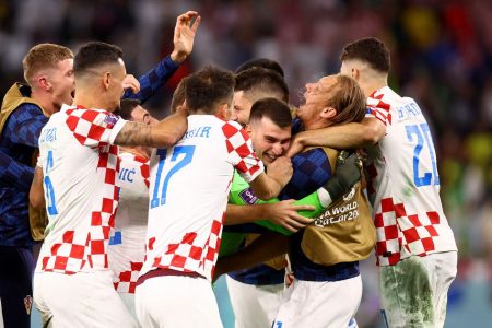 Croatia's Dominik Livakovic celebrates with teammates after winning the penalty shootout and qualifying for the semi final REUTERS/Hannah Mckay