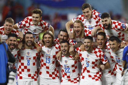 Croatia players celebrate after the match as they finish in third place. REUTERS/Peter Cziborra
