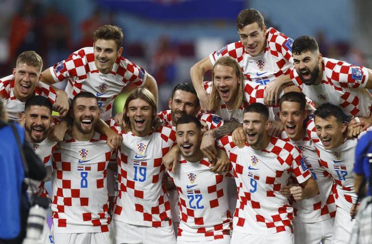 Croatia players celebrate after the match as they finish in third place. REUTERS/Peter Cziborra
