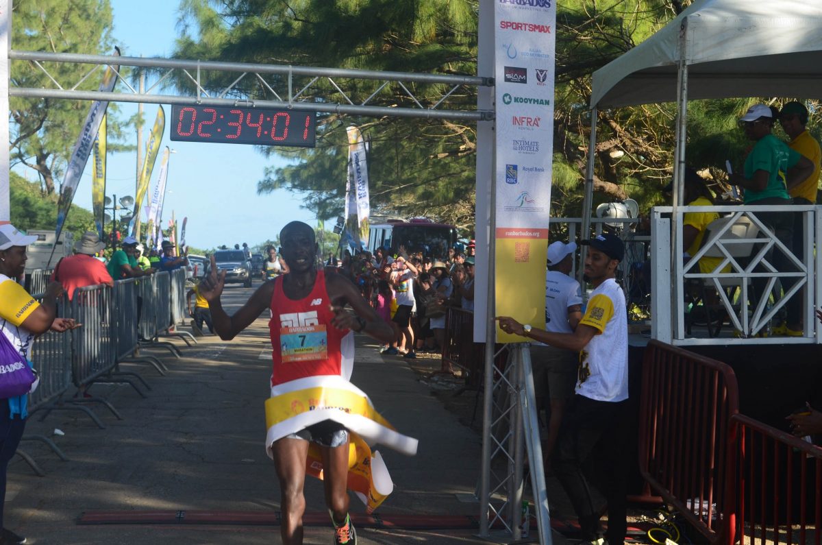 Daylight! Marathon Men’s winner Alex Ekesa of Kenya crossing the finish line unchallenged which was the story of the race to successfully retain his title in the Barbados Marathon. 
