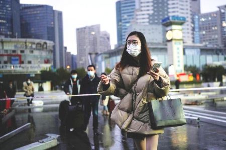 A woman wearing a face mask walks outside the Shanghai Railway Station in Shanghai, China December 8, 2022. ― Reuters pic