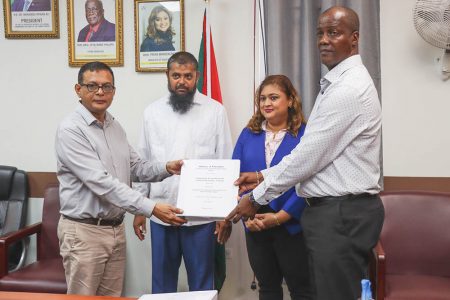 (From left) Principal Contractor of Deen + Partners Deen Kamaludeen, Chief Education Officer Saddam Hussain, Education Minister, Priya Manickchand, and Permanent Secretary, Alfred King with the contract for the completion of the Good Hope Secondary School (Ministry of Education photo) 