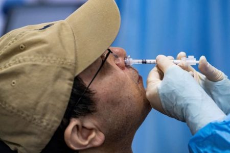 A nasal spray vaccine being administered (Reuters photo)