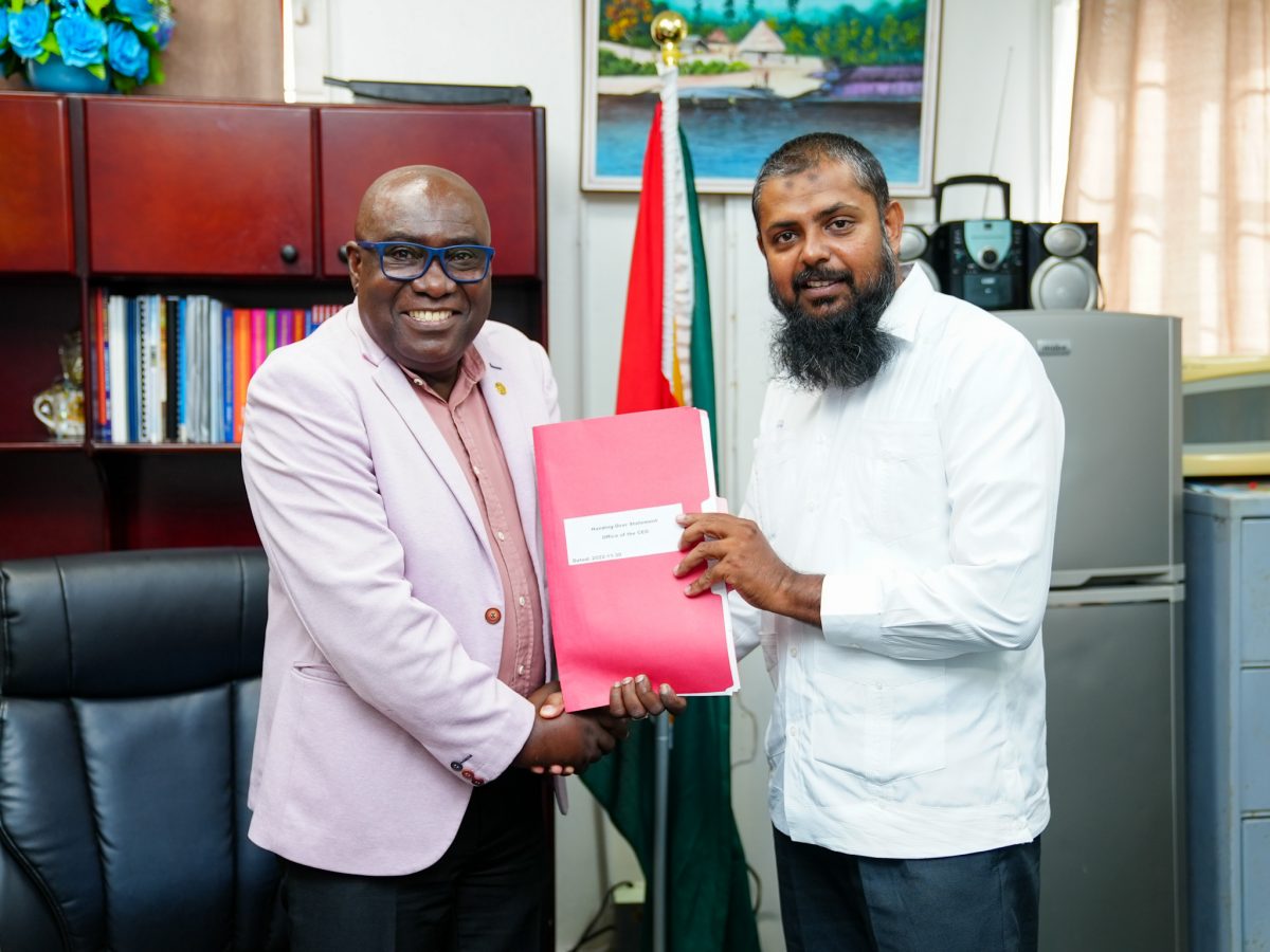 Saddam Hussain (right) in a handover with Dr Marcel Hutson (Ministry of Education photo)