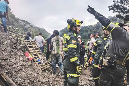 Rescuers working at the site of a landslide where at least 34 people died, in northwestern Bogota, Colombia, on 4 December 2022. Photo: AFP / Colombia’s National Police Press Office 