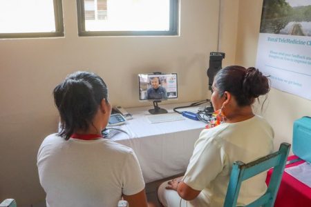 A patient and a Community Health Worker utilising the telemedicine programme at the Gunns Village Health Post  (Department of Public Information photo)