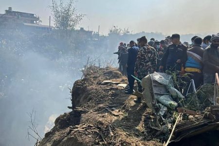 Rescuers and onlookers gather at the site of a plane crash in Pokhara on January 15, 2023. An aircraft with 72 people on board crashed in Nepal on January 15, Yeti Airlines and a local official said.
Krishna Mani Baral | Afp | Getty Images
