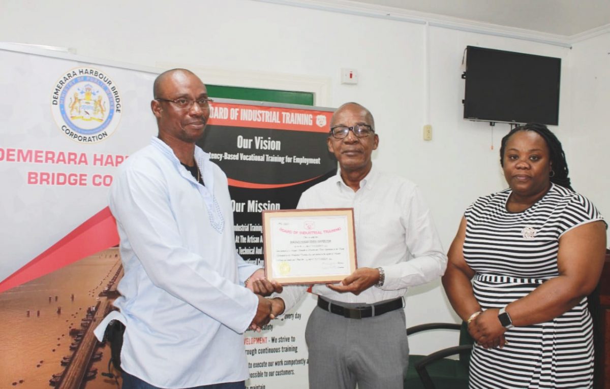 From left, General Manager of DHBC, Wayne Watson collecting the Masters of Apprenticeship certificate from Minister of Labour Joseph Hamilton and BIT’s Acting Chief Executive Officer/Secretary Saskia Eastman-Onwuzirike