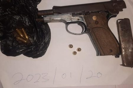 The firearm and ammunition that were found in the vehicle. (Police photo)