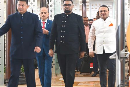President Irfaan Ali (centre) has arrived in India. At right is India’s High Commissioner to Guyana, Dr K J Srinivasa. (Office of the President photo)