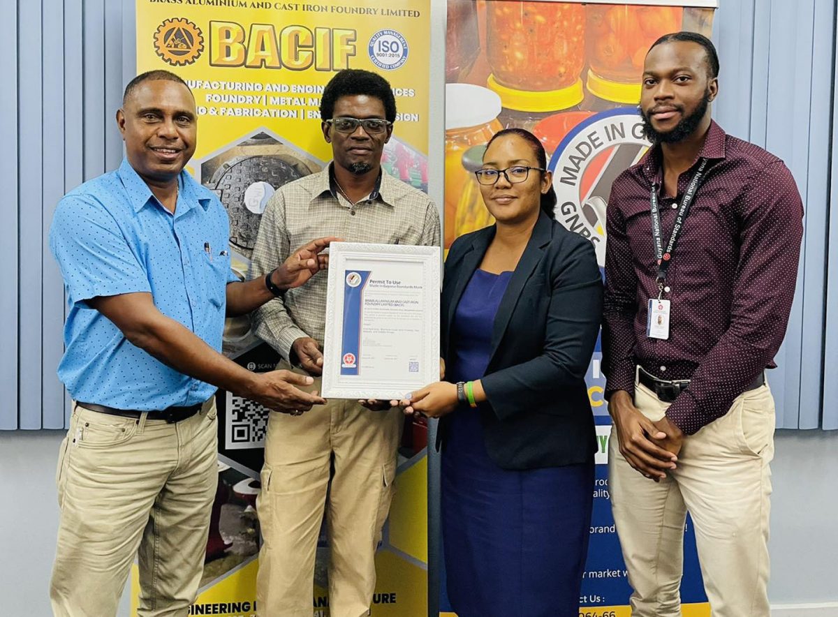 From left, Rondel Ali and Adrian Barkoye receiving the mark on behalf of BACIF (GNBS photo)