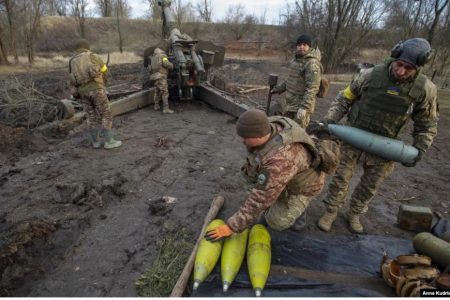 Ukrainian soldiers prepare cannon shells before firing them toward Russian positions in Donetsk region on January 1.