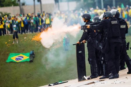 Security forces clash with supporters of former President Jair Bolsonaro outside Brazil’s National Congress in Brasilia