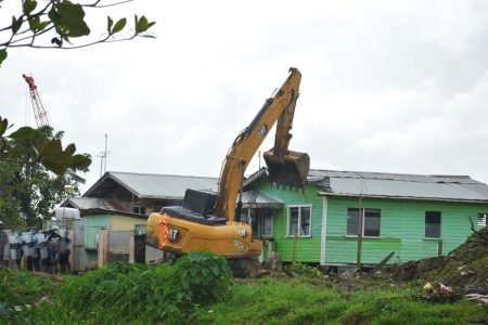 A bulldozer about to tear down one of the houses yesterday.