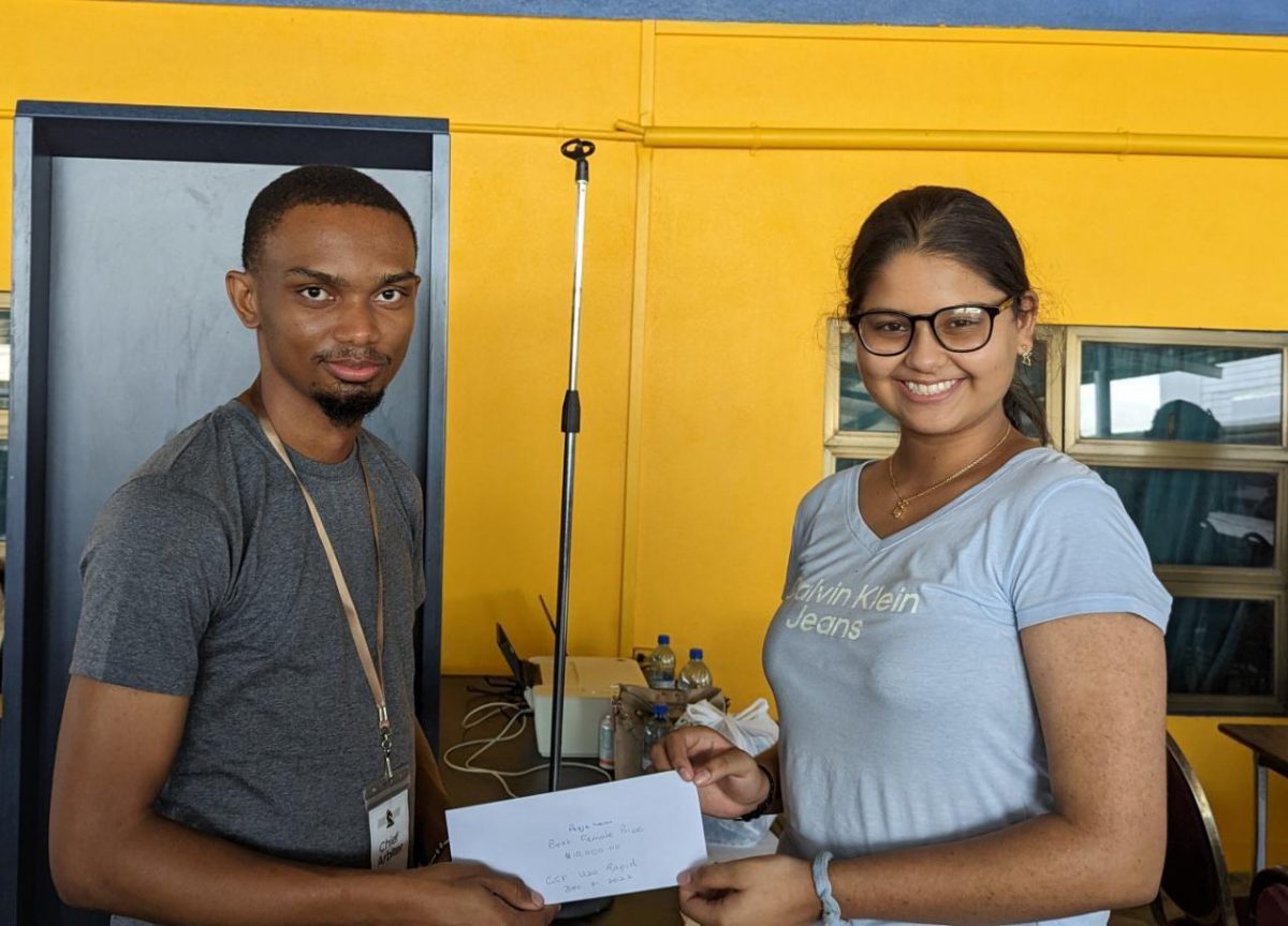 Pooja Lam (right) receives her monetary prize from national player Anthony Drayton who officiated in this January’s Rapid Tournament which was hosted by the Guyana Chess Federation for juniors 20-years and under. Pooja, 14, was adjudged the Best Female in the tournament, and finished fifth in the overall competition