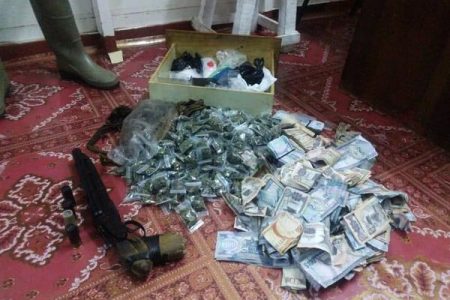 The suspected ganja and cash that were found (Police photo)