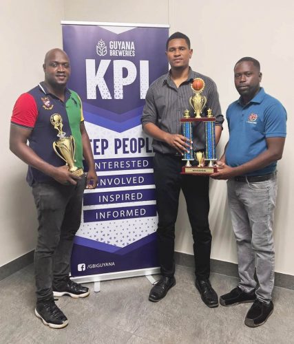 Devon Dover, GBI’s Trade Marketing Executive (first from right), makes the presentation of trophies to GABA president Jermaine Slater and LABA president Rawle Toney, left.
