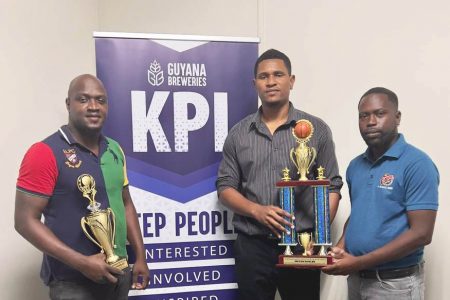 Devon Dover, GBI’s Trade Marketing Executive (first from right), makes the presentation of trophies to GABA president Jermaine Slater and LABA president Rawle Toney, left.
