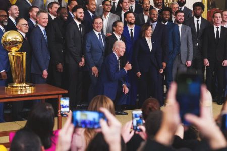 President Joe Biden kneels as he and Vice President Kamala Harris take a photo with the Golden State Warriors to the East Room of the White House to celebrate their 2022 NBA championship. Mandatory Credit: Josh Morgan-USA TODAY
