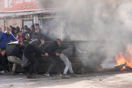 Palestinians clash with Israeli forces following an army raid in the West Bank city of Jenin, Thursday, Jan. 26, 2023. (AP Photo/Majdi Mohammed)