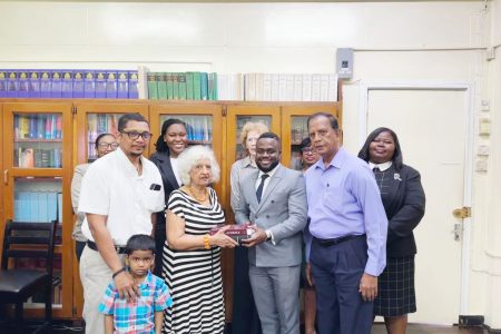 In photograph from left to right are: (front row)  Garry Fitzpatrick with his son Michael;  Sultana Fitzpatrick; Reon Miller;  Bishwa Panday; (back row) Shaunessy Profitt; Renee McDonald; Josephine Whitehead;  Gaitre Persaud;  Shellon Boyce.
