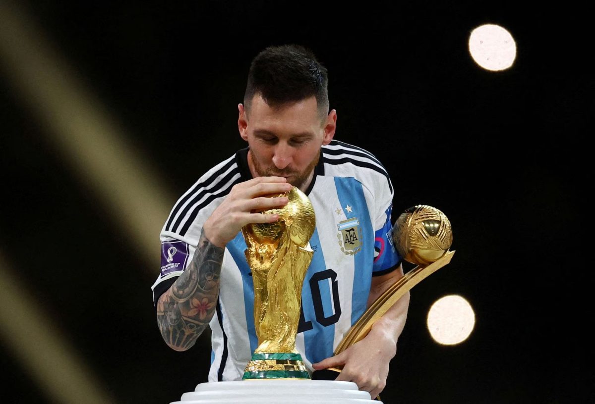 Argentina’s Lionel Messi kisses the World Cup trophy after receiving the Golden Ball award as he celebrates after winning the World Cup REUTERS/Kai Pfaffenbach/File Photo