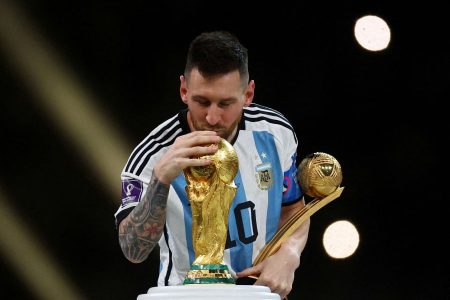 Argentina’s Lionel Messi kisses the World Cup trophy after receiving the Golden Ball award as he celebrates after winning the World Cup REUTERS/Kai Pfaffenbach/File Photo