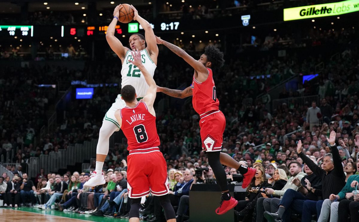 Boston Celtics forward Grant Williams (12) grabs the rebound against Chicago Bulls guard Zach LaVine (8) and guard Coby White (0) in the second half at TD Garden. Mandatory Credit: David Butler II-USA TODAY Sports.