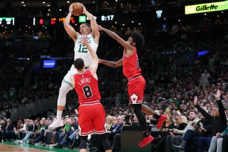 Boston Celtics forward Grant Williams (12) grabs the rebound against Chicago Bulls guard Zach LaVine (8) and guard Coby White (0) in the second half at TD Garden. Mandatory Credit: David Butler II-USA TODAY Sports.