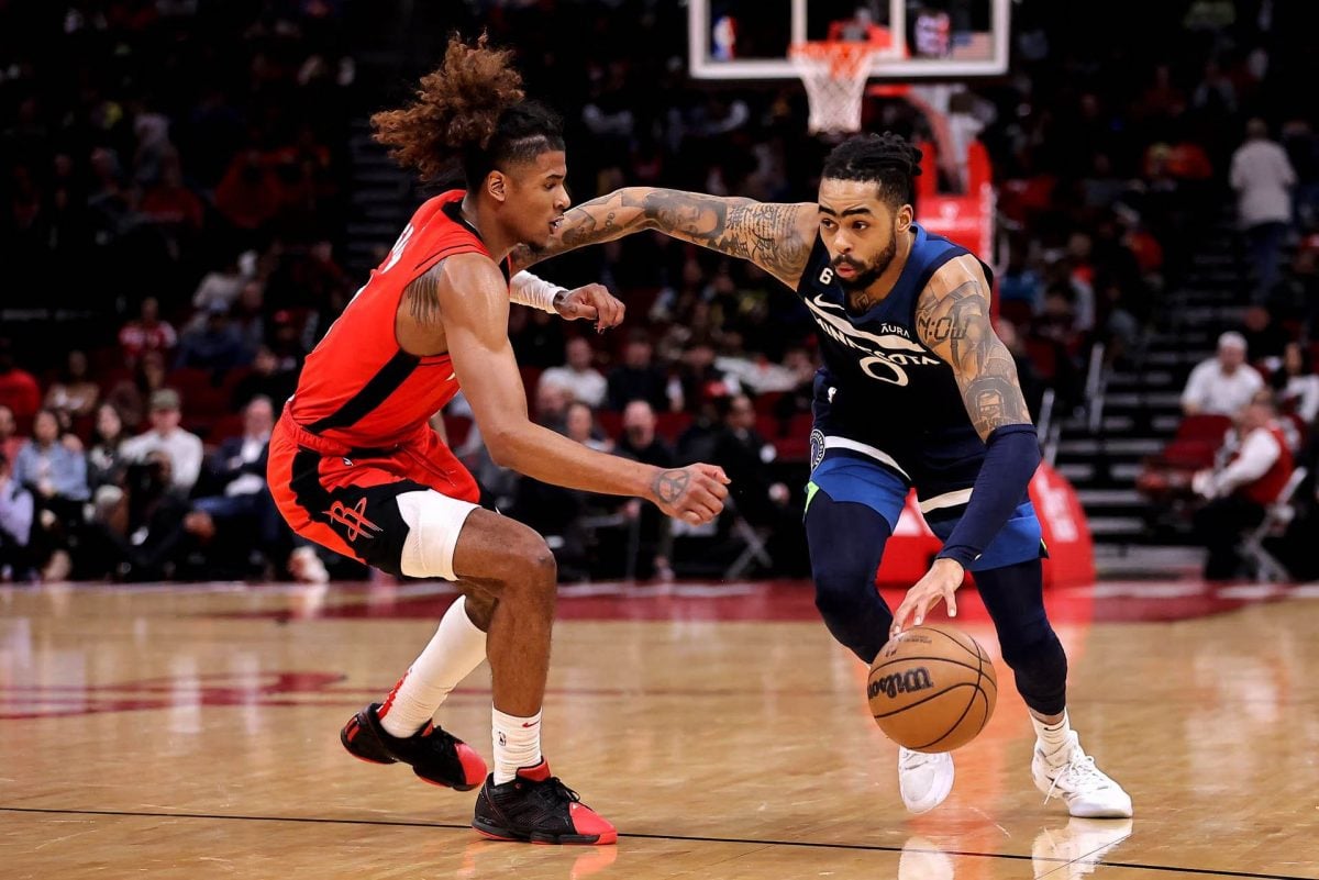 Minnesota Timberwolves guard D’Angelo Russell (0) drives to the basket while Houston Rockets guard Jalen Green (4) defends during the fourth quarter at Toyota Center. Mandatory Credit: Erik Williams-USA TODAY Sports.